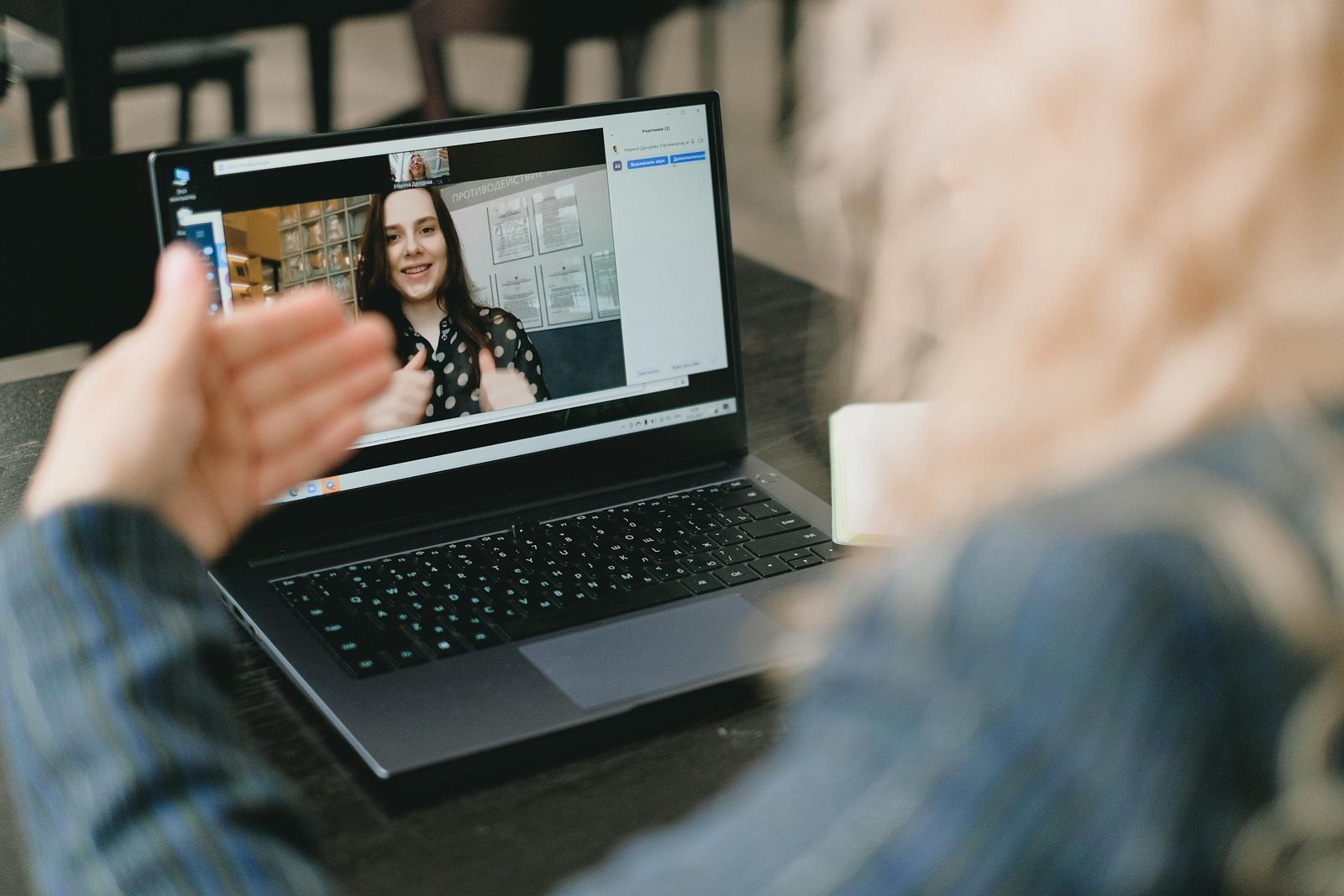 Businesswoman having a productive video call meeting using a laptop in a professional setting.