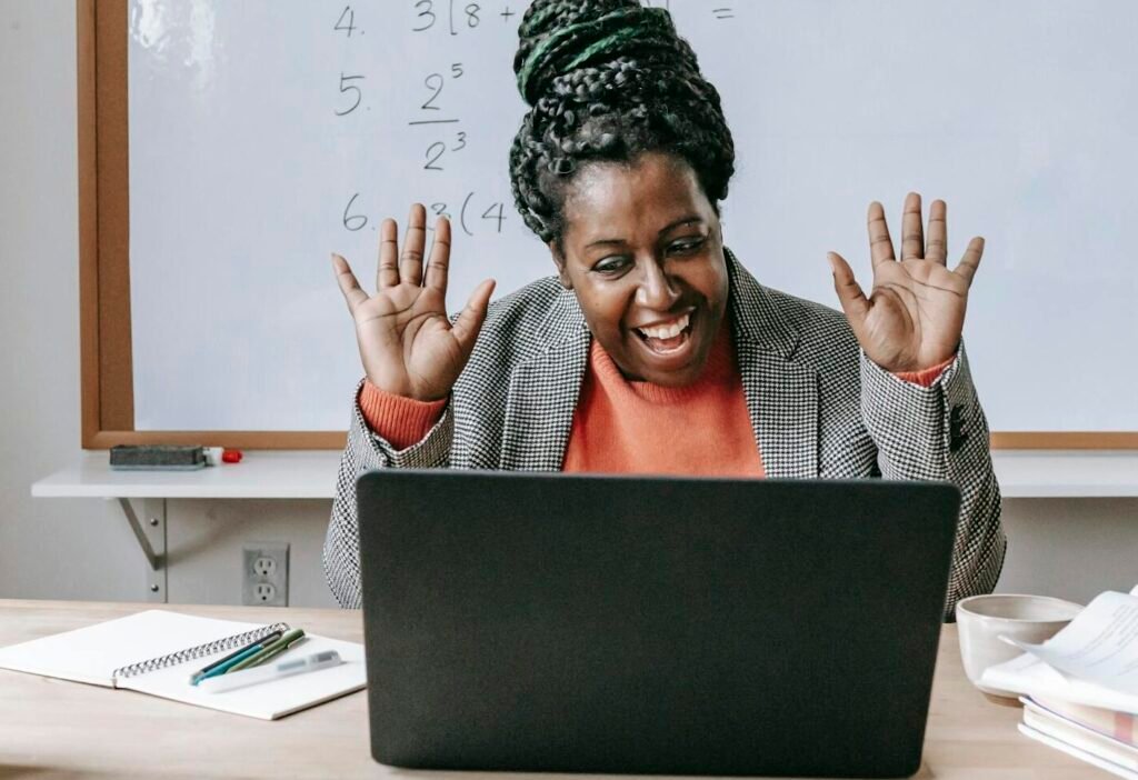 Smiling teacher enjoying an online math class with equations on whiteboard.